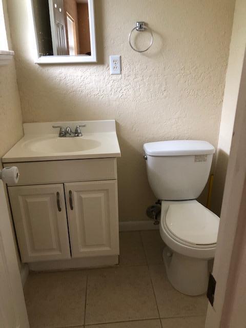 7407 Sebastian Road Fort Pierce, FL 34951 - Photo 8 of 13 a bathroom with a toilet sink and mirror