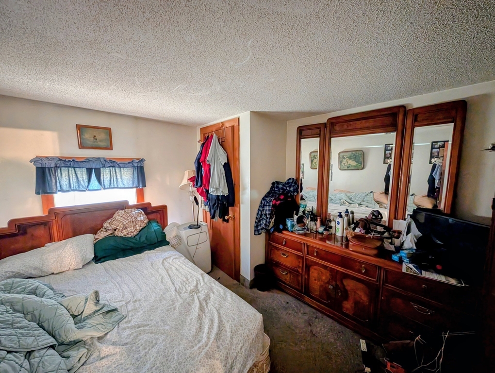 7 Little Mugget Road Charlton, MA 01507 - Photo 11 of 42 a bedroom with a bed and a closet