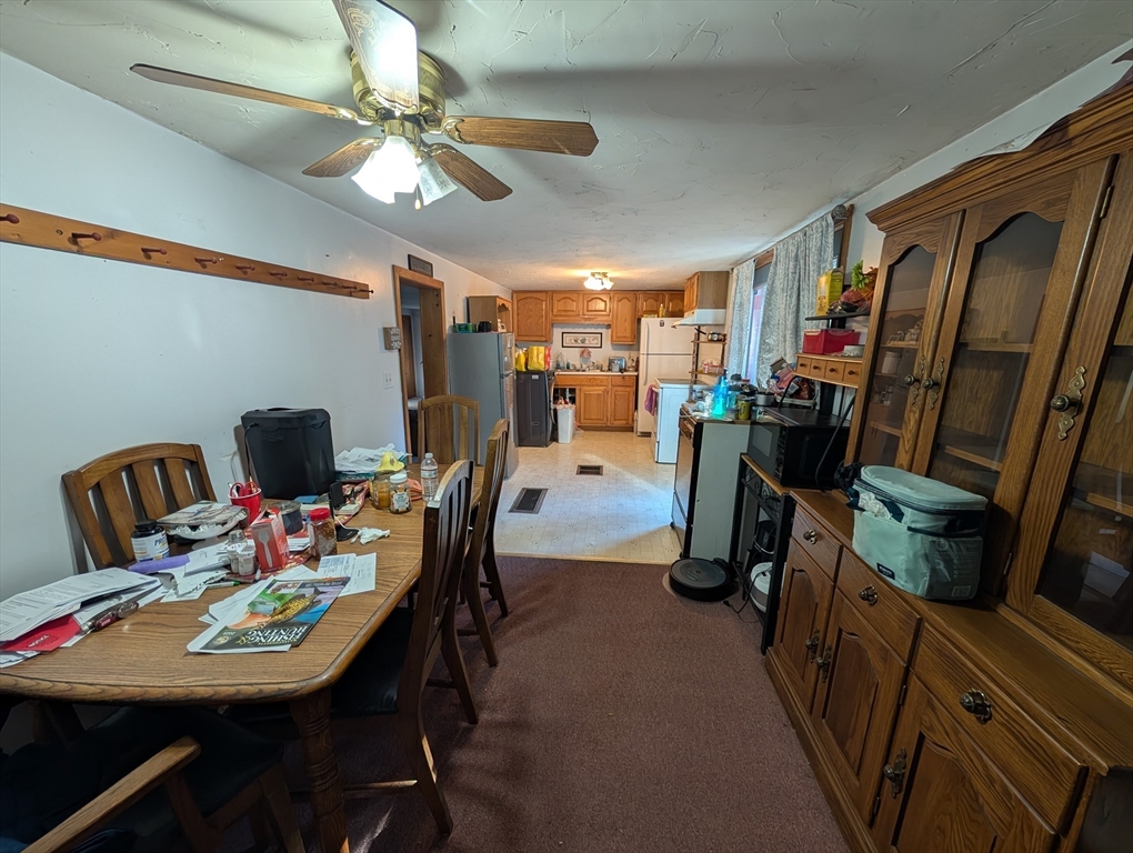 7 Little Mugget Road Charlton, MA 01507 - Photo 12 of 42 a view of a dining room with furniture and a chandelier