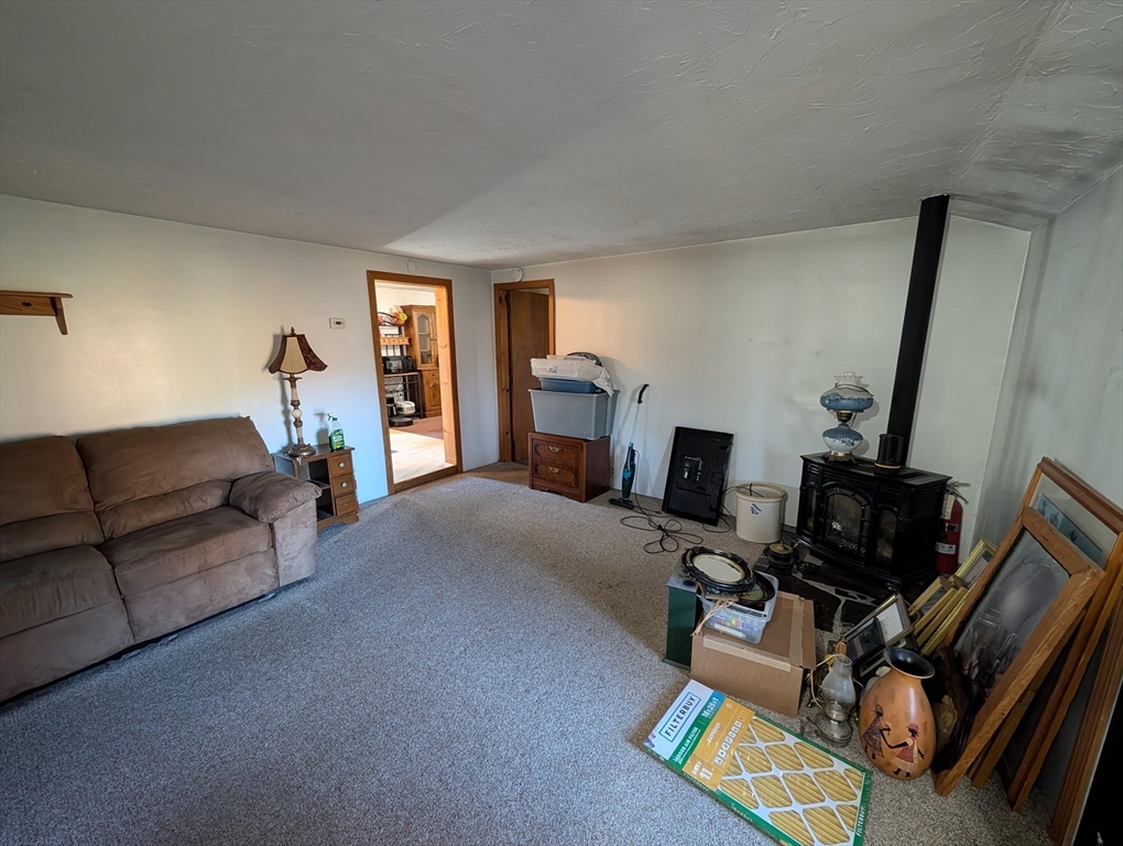 7 Little Mugget Road Charlton, MA 01507 - Photo 13 of 42 a living room with furniture and a flat screen tv