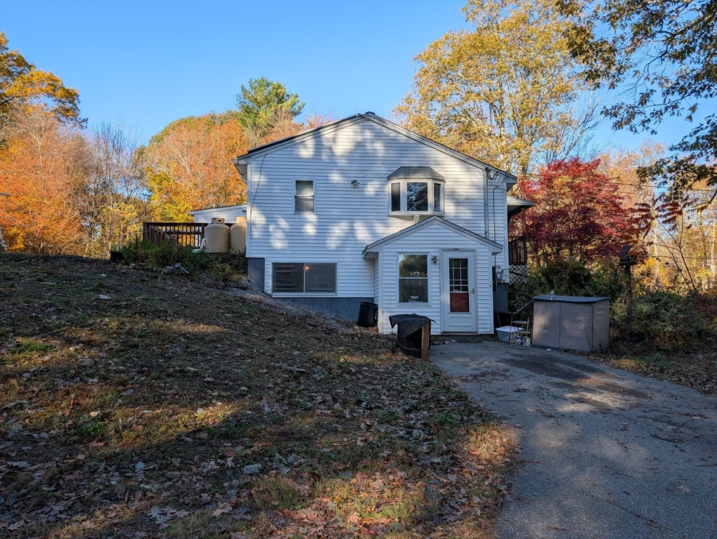 7 Little Mugget Road Charlton, MA 01507 - Photo 2 of 42 a view of a white house with a yard and large trees