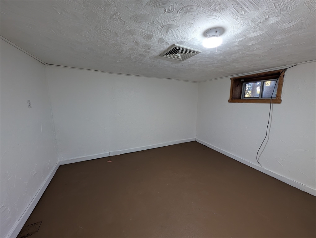 7 Little Mugget Road Charlton, MA 01507 - Photo 21 of 42 an empty room with a empty space and windows