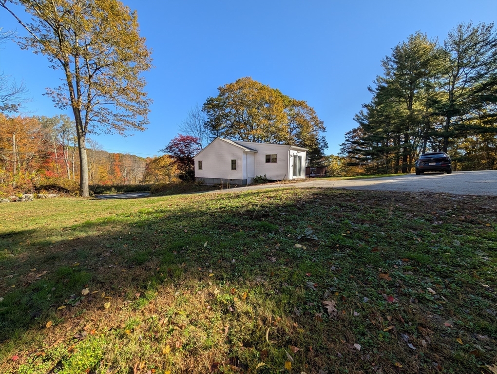 7 Little Mugget Road Charlton, MA 01507 - Photo 26 of 42 a view of a big house with a big yard and large trees