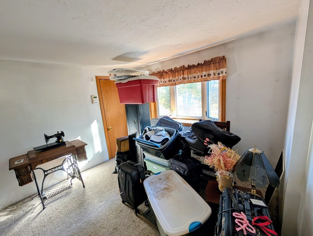 7 Little Mugget Road Charlton, MA 01507 - Photo 31 of 42 a room with furniture a rug and a window