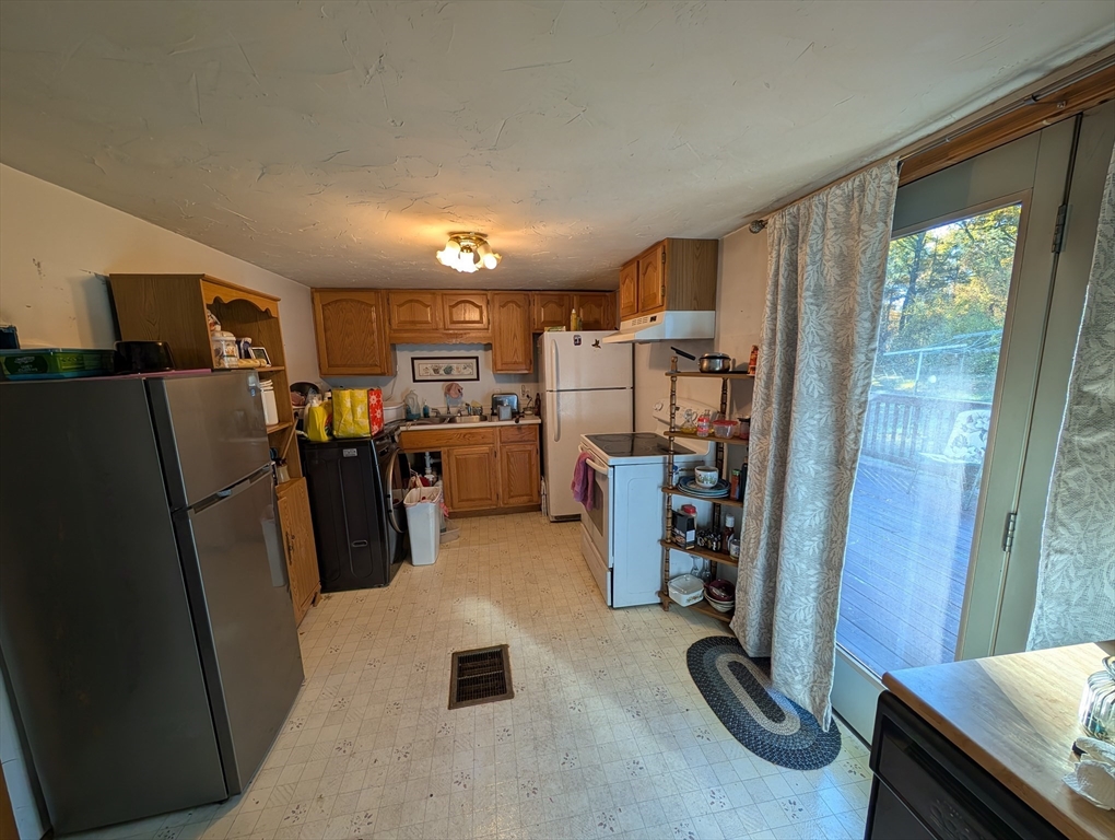7 Little Mugget Road Charlton, MA 01507 - Photo 4 of 42 a view of a kitchen with fridge and workspace