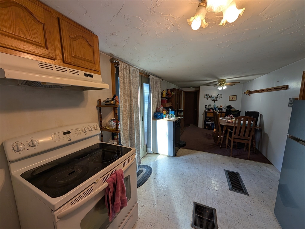 7 Little Mugget Road Charlton, MA 01507 - Photo 5 of 42 a kitchen with wooden cabinets and a stove top oven