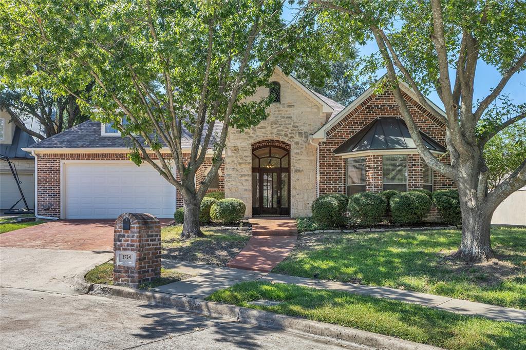 1714 Morrish Lane Heath, TX 75032 - Photo 1 of 33 a front view of a house with garden