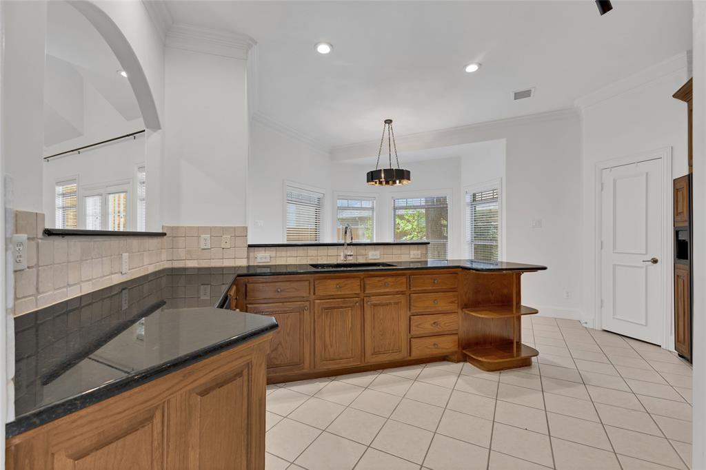 1714 Morrish Lane Heath, TX 75032 - Photo 13 of 33 a kitchen with stainless steel appliances a sink stove and cabinets