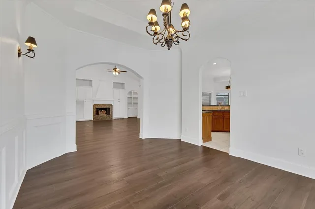 a view of a livingroom with wooden floor and a chandelier
