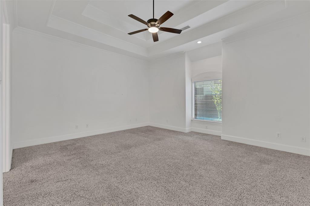 1714 Morrish Lane Heath, TX 75032 - Photo 18 of 33 an empty room with a window and a ceiling fan