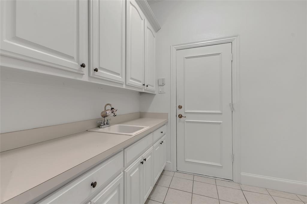1714 Morrish Lane Heath, TX 75032 - Photo 25 of 33 a view of a kitchen with white cabinets