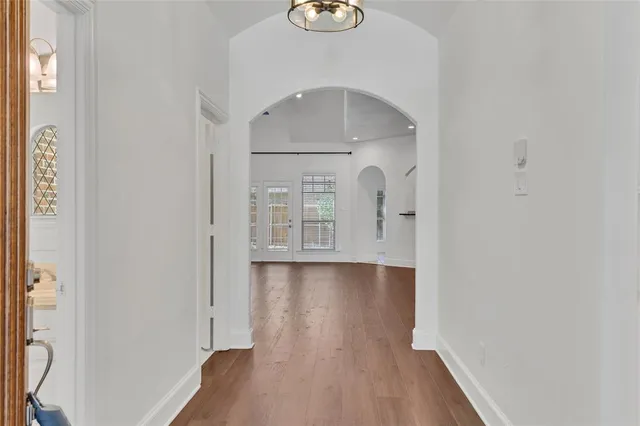 a view of empty room with wooden floor