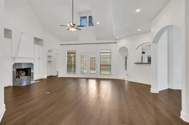 a view of empty room with wooden floor and fireplace