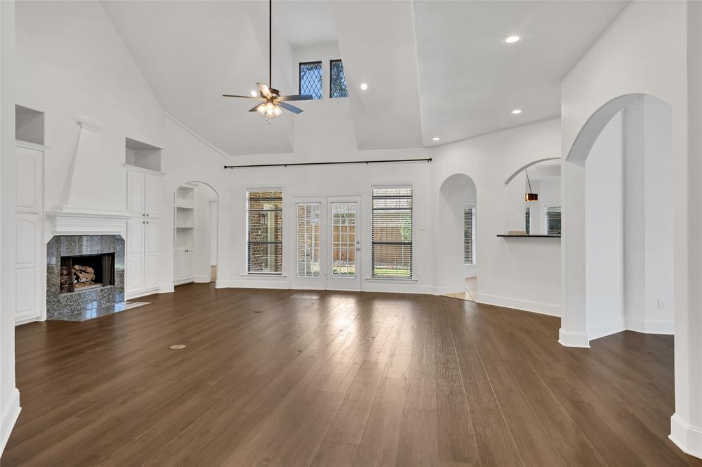 1714 Morrish Lane Heath, TX 75032 - Photo 5 of 33 a view of empty room with wooden floor and fireplace
