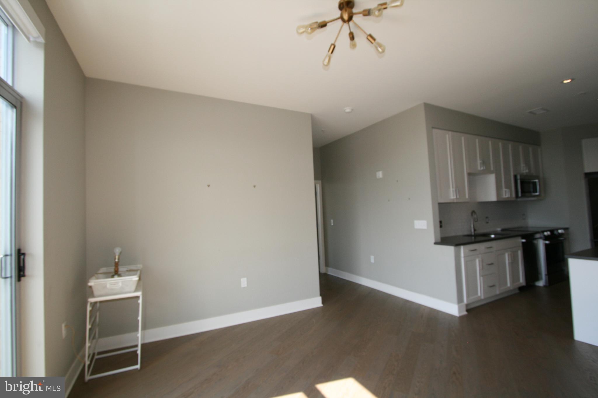 2550 17th Street Northwest, Unit 612 Washington, DC 20009 - Photo 45 of 55 a kitchen with granite countertop a stove and a refrigerator
