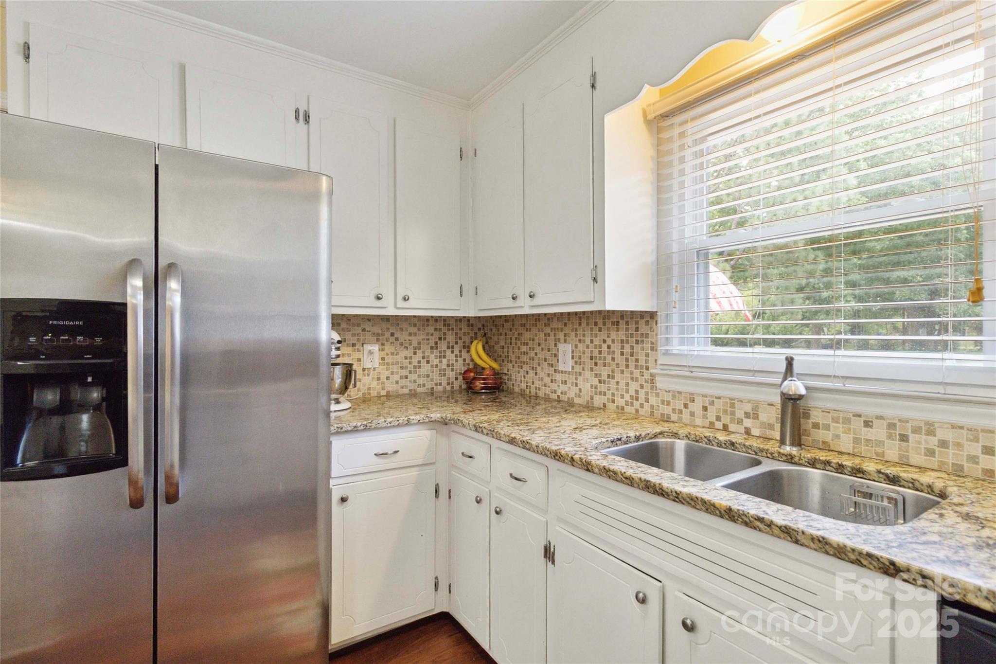 1219 Flowe Drive Matthews, NC 28104 - Photo 12 of 30 a kitchen with stainless steel appliances granite countertop a refrigerator a sink and white cabinets