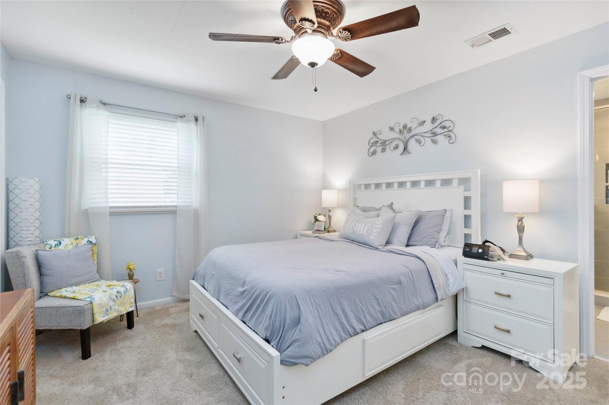 1219 Flowe Drive Matthews, NC 28104 - Photo 14 of 30 a bedroom with a bed and a chandelier