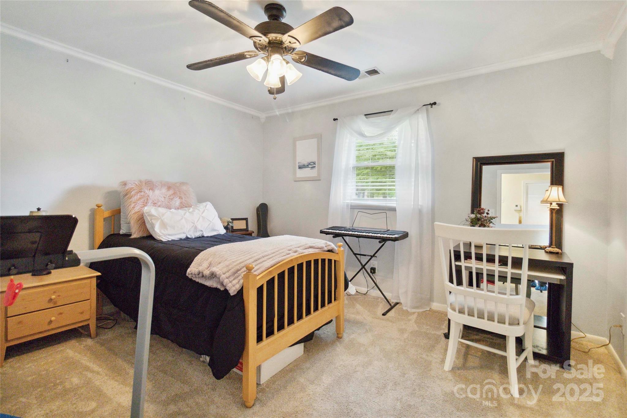 1219 Flowe Drive Matthews, NC 28104 - Photo 20 of 30 a bedroom with a bed and a chandelier