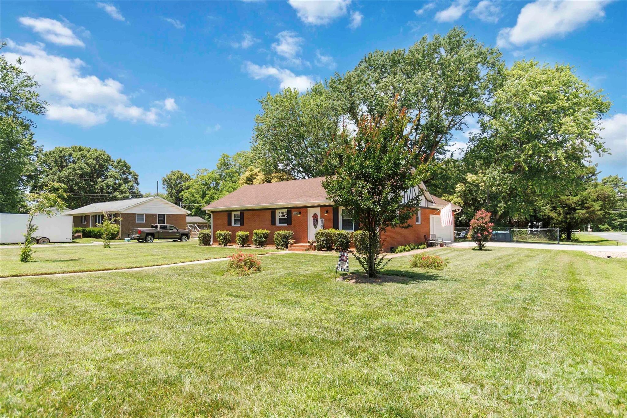 1219 Flowe Drive Matthews, NC 28104 - Photo 2 of 30 a house with swimming pool in front of it