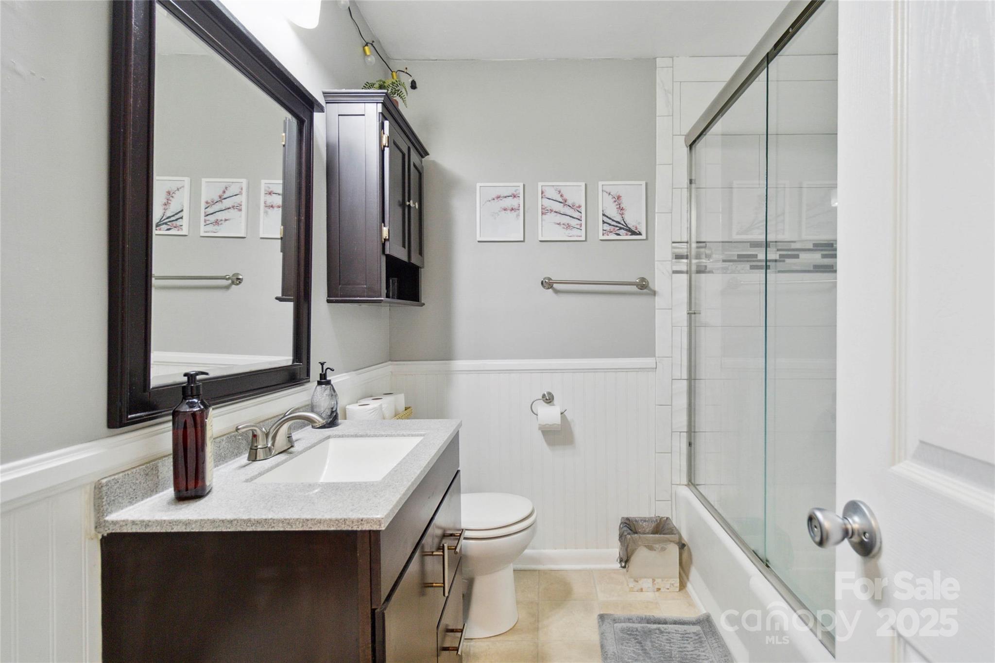 1219 Flowe Drive Matthews, NC 28104 - Photo 21 of 30 a bathroom with a granite countertop sink toilet and shower