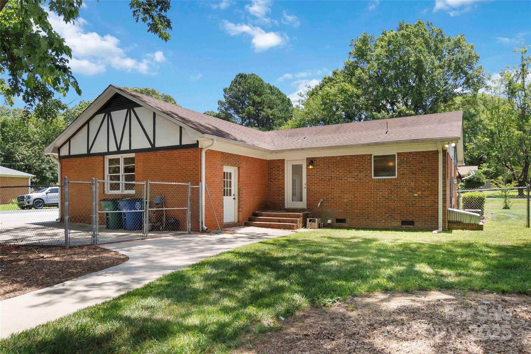1219 Flowe Drive Matthews, NC 28104 - Photo 25 of 30 a view of a house with backyard and sitting area