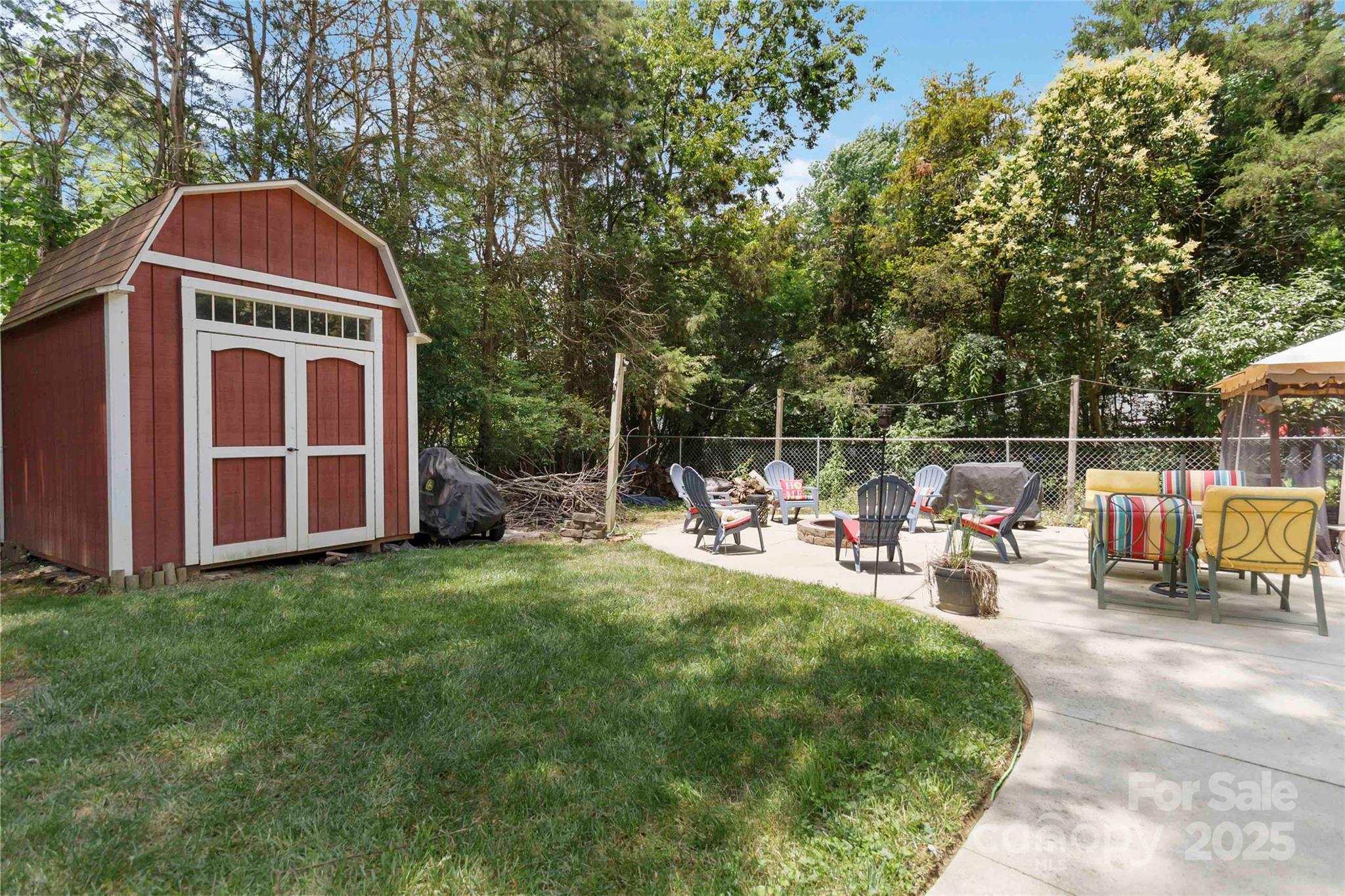 1219 Flowe Drive Matthews, NC 28104 - Photo 27 of 30 a view of a yard with large trees and a barn