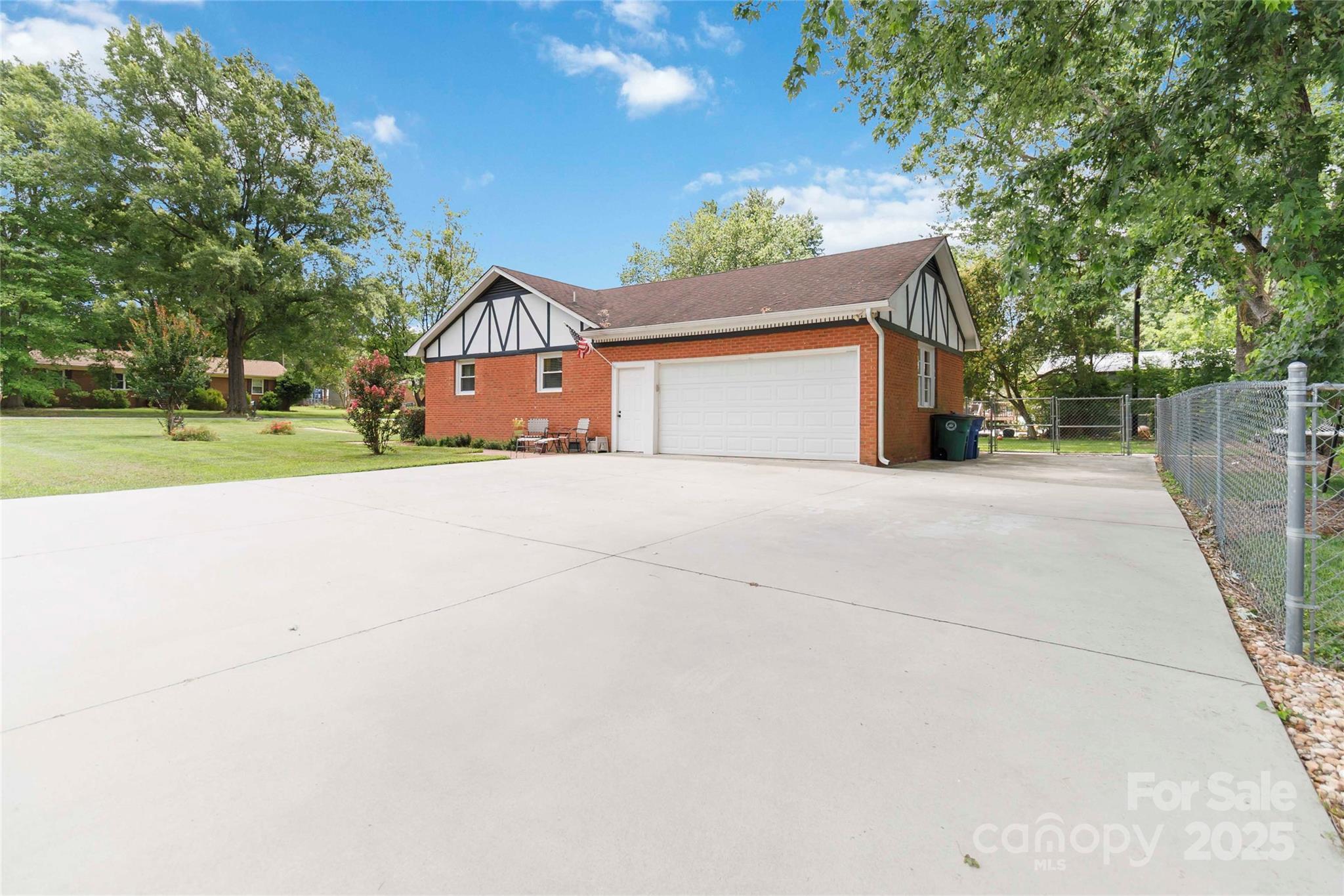 1219 Flowe Drive Matthews, NC 28104 - Photo 30 of 30 a front view of a house with a yard and garage