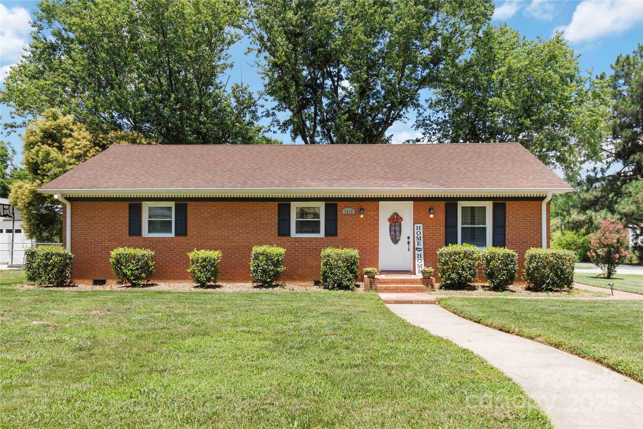 1219 Flowe Drive Matthews, NC 28104 - Photo 3 of 30 a front view of a house with yard and green space