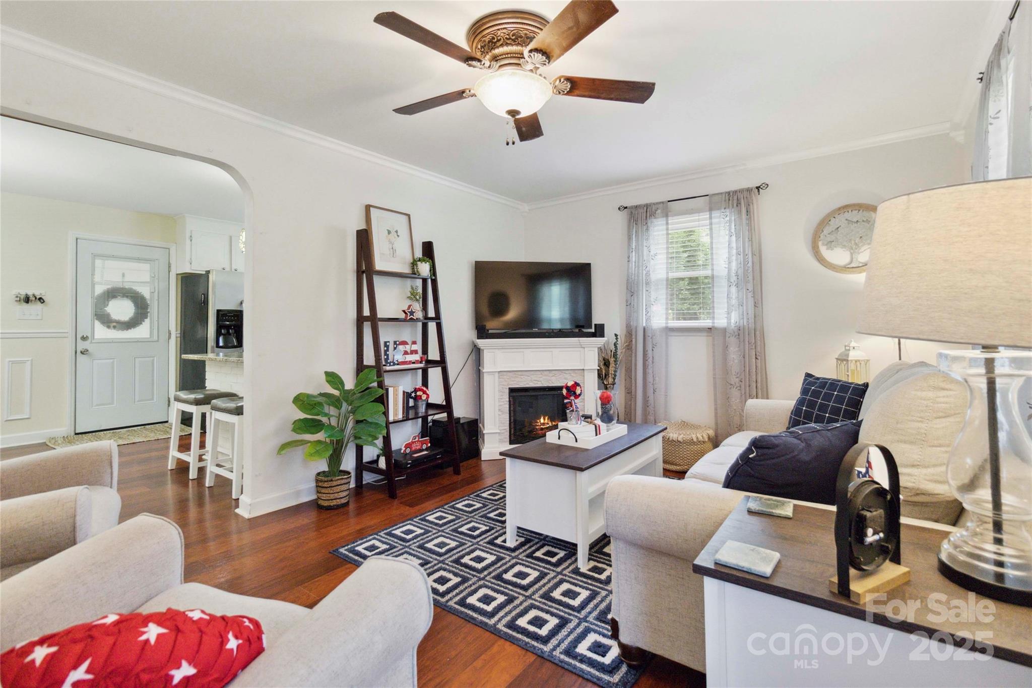 1219 Flowe Drive Matthews, NC 28104 - Photo 7 of 30 a living room with furniture a fireplace and a flat screen tv