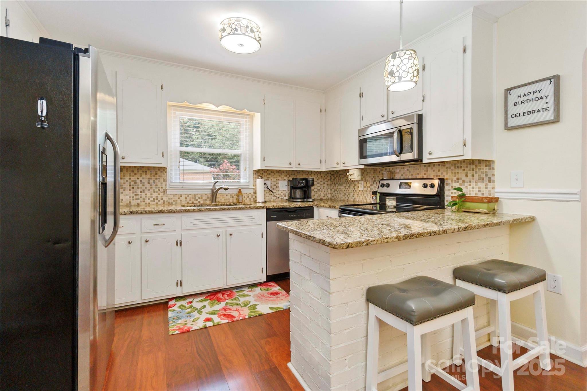 1219 Flowe Drive Matthews, NC 28104 - Photo 8 of 30 a kitchen with granite countertop a sink appliances cabinets and furniture
