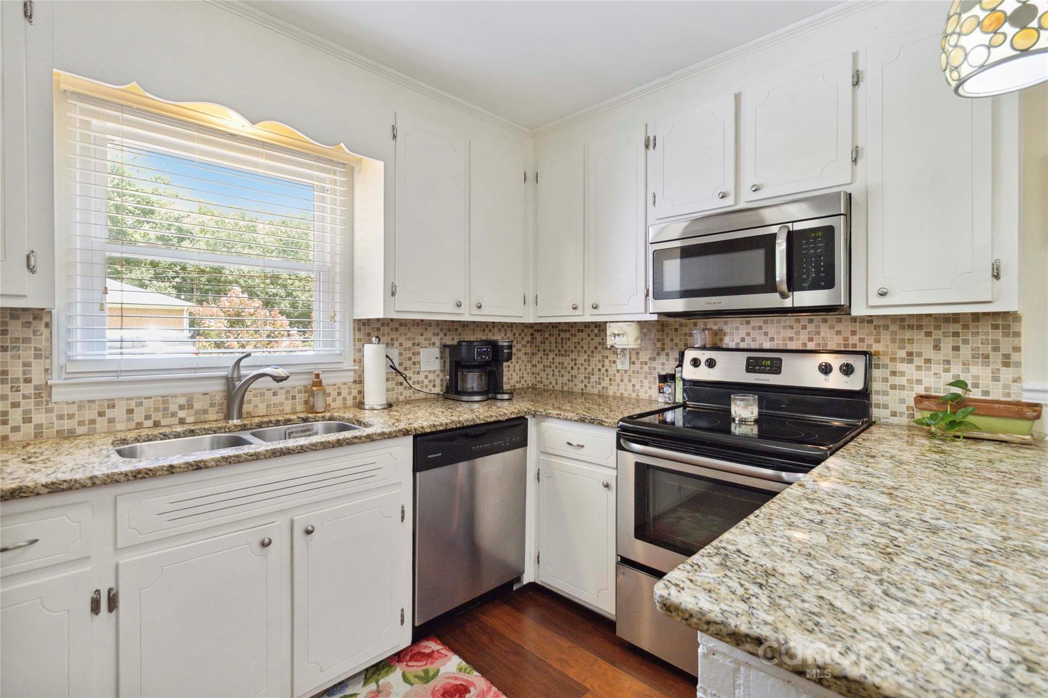 1219 Flowe Drive Matthews, NC 28104 - Photo 10 of 30 a kitchen with granite countertop cabinets stainless steel appliances a sink and window