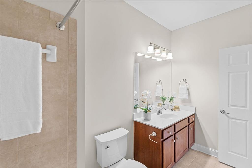 2716 Grapevine Circle Cumming, GA 30041 - Photo 21 of 37 a bathroom with a sink a mirror and a toilet