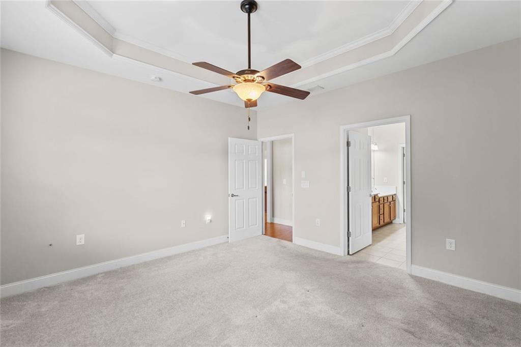 2716 Grapevine Circle Cumming, GA 30041 - Photo 23 of 37 a view of a room with chandelier fan