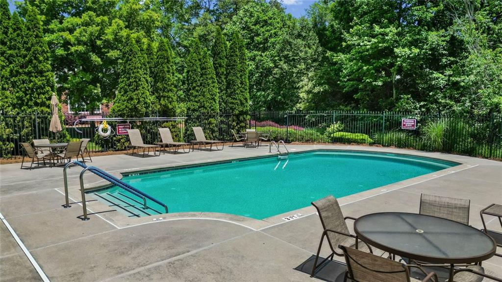 2716 Grapevine Circle Cumming, GA 30041 - Photo 36 of 37 a view of a swimming pool with chairs in roof deck