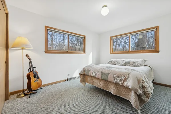 a bedroom with a bed and a painting on the wall