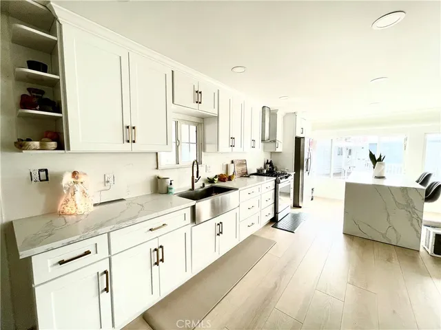 a large white kitchen with cabinets