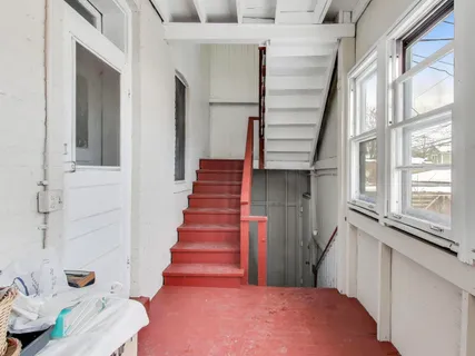 a view of a hallway with wooden floor and entryway