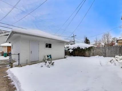 a view of a house with a snow in the yard