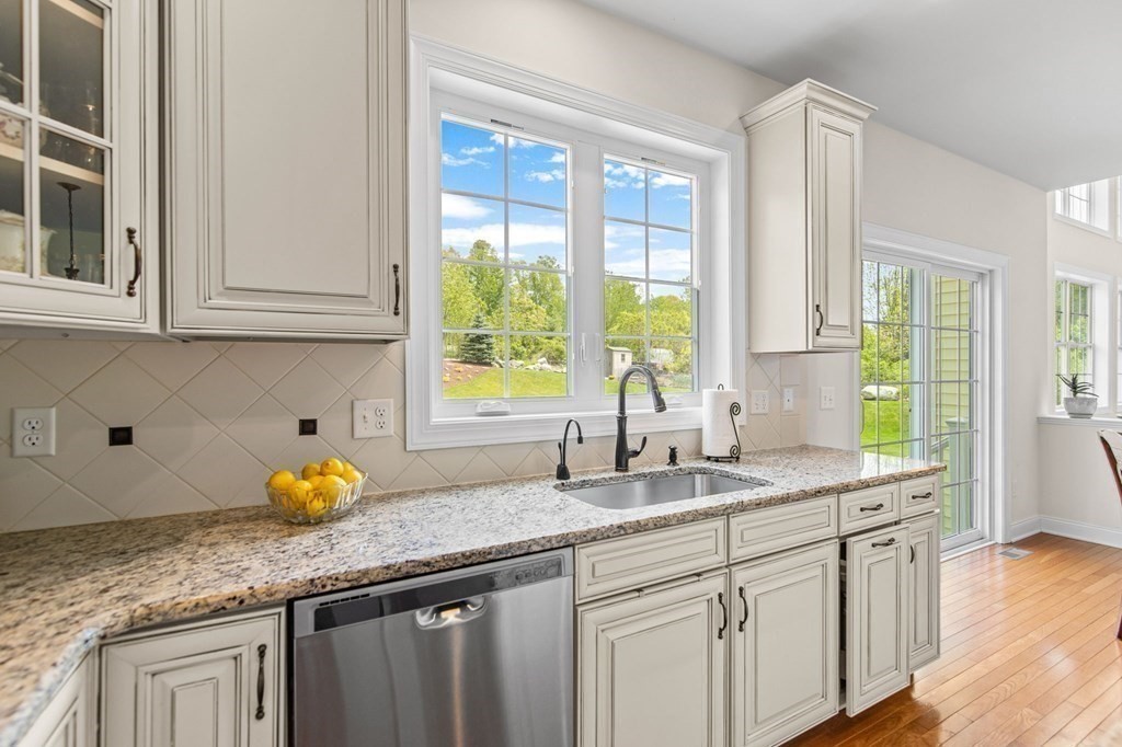 14 Pine Tree Drive Methuen, MA 01844 - Photo 11 of 42 a kitchen with granite countertop white cabinets and a window