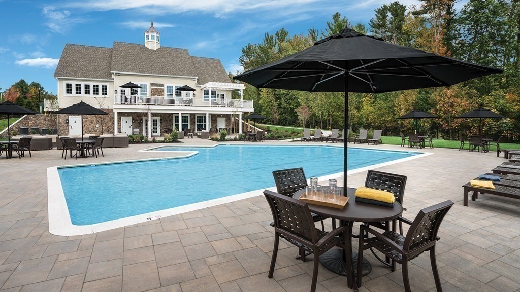 14 Pine Tree Drive Methuen, MA 01844 - Photo 38 of 42 a view of a patio with table and chairs under an umbrella