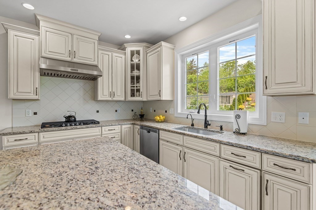 14 Pine Tree Drive Methuen, MA 01844 - Photo 9 of 42 a kitchen with stainless steel appliances granite countertop a sink a stove and cabinets