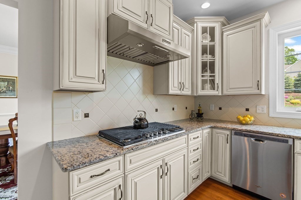 14 Pine Tree Drive Methuen, MA 01844 - Photo 10 of 42 a kitchen with stainless steel appliances granite countertop a sink dishwasher a stove and cabinets with wooden floor