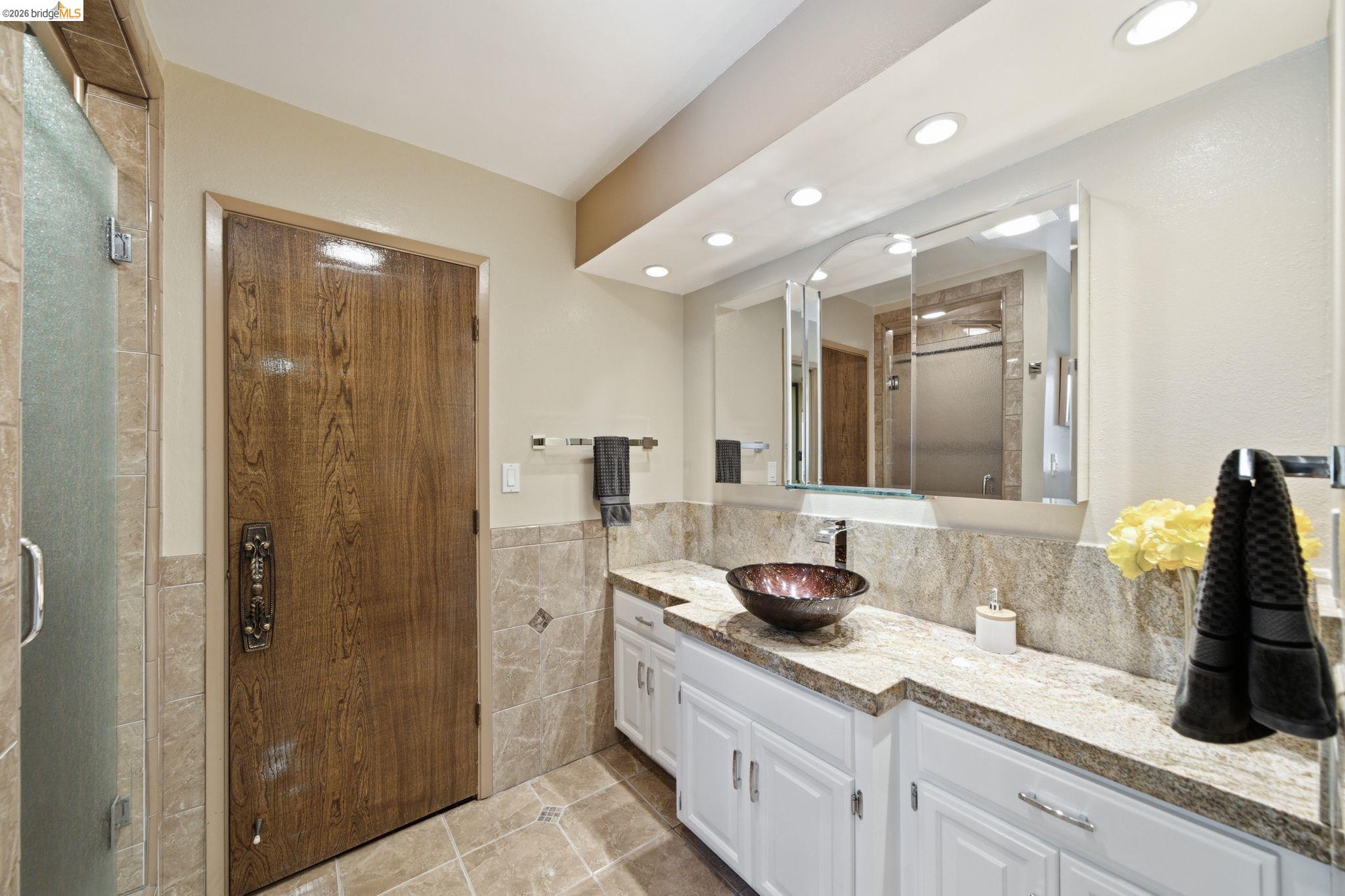 11133 Golf Links Road Oakland, CA 94605 - Photo 34 of 57 Bathroom featuring a vessel sink, stone countertop, white cabinetry, and recessed lighting