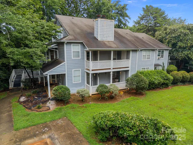 a front view of a house with a yard and porch