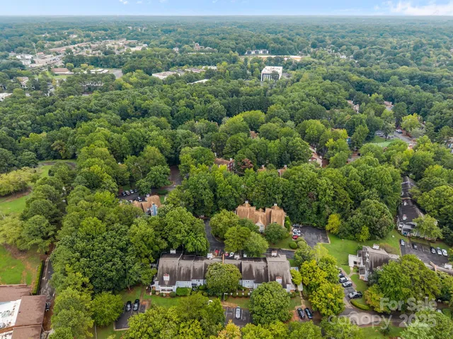 an aerial view of a city with lots of residential buildings and mountain view