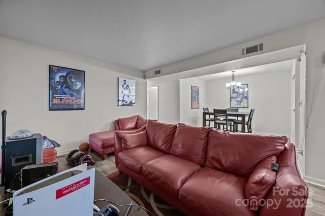 a living room with furniture and a wooden floor