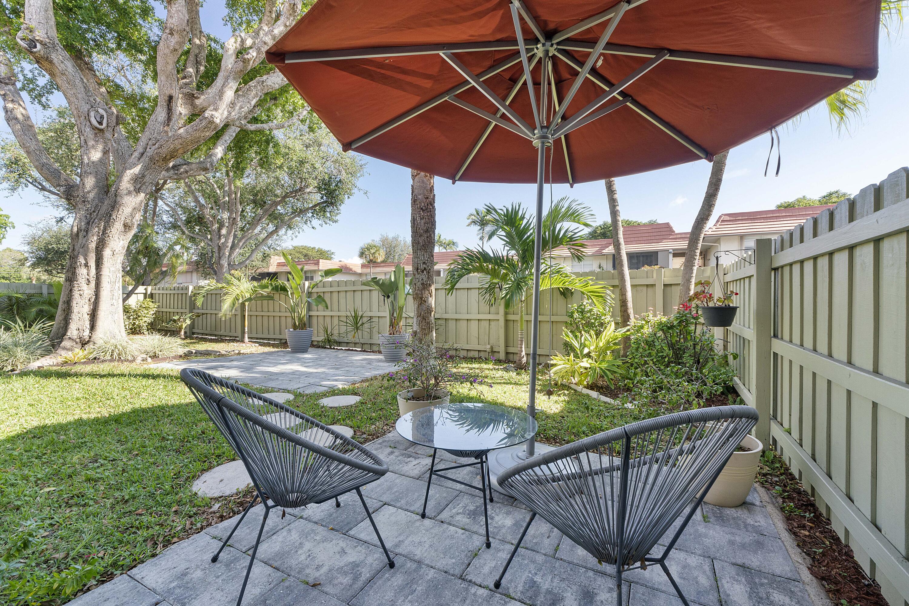 a view of an outdoor sitting area with furniture and umbrella