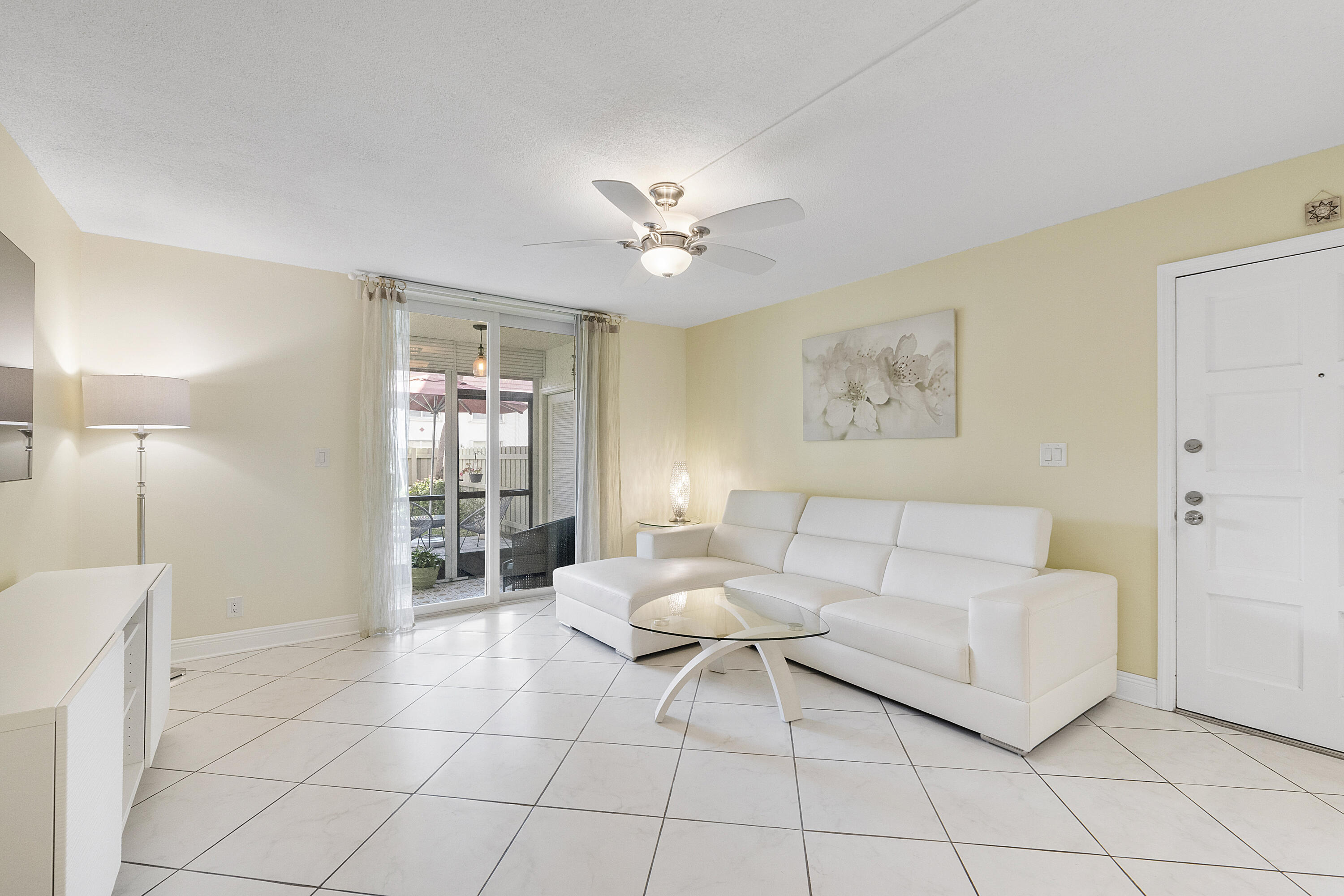1100 Northwest 13th Street, Unit 192D Boca Raton, FL 33486 - Photo 13 of 42 a living room with furniture and a chandelier