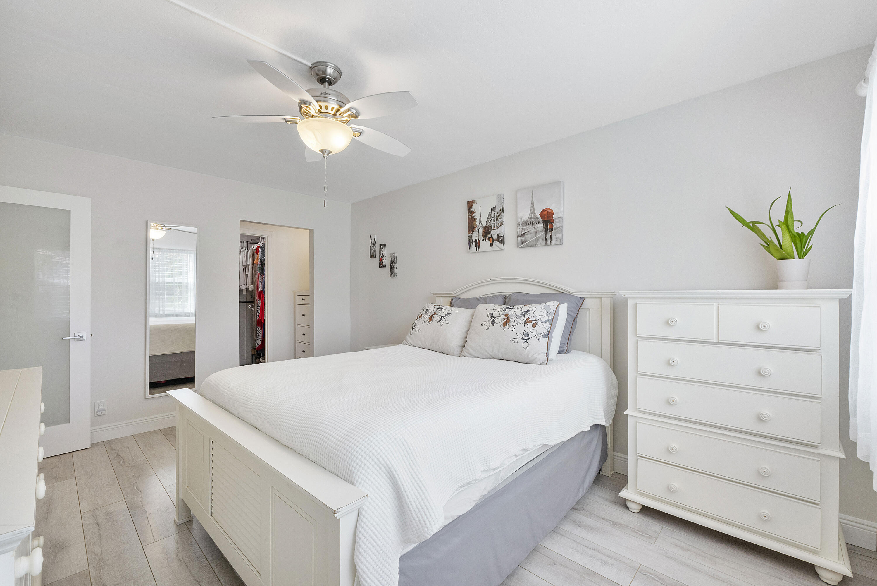 1100 Northwest 13th Street, Unit 192D Boca Raton, FL 33486 - Photo 15 of 42 a bedroom with a large bed and a chandelier