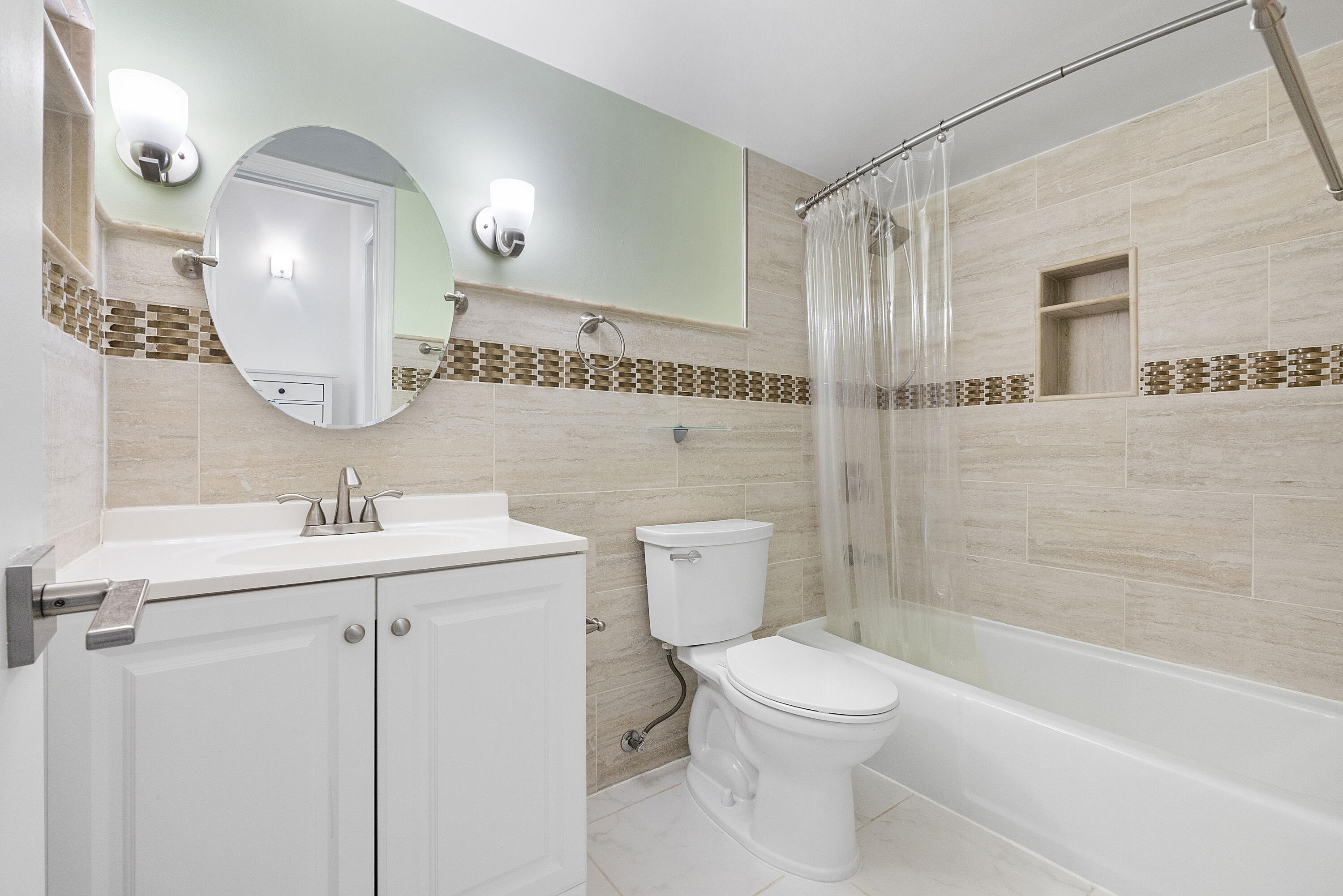 1100 Northwest 13th Street, Unit 192D Boca Raton, FL 33486 - Photo 18 of 42 a bathroom with a toilet sink and mirror